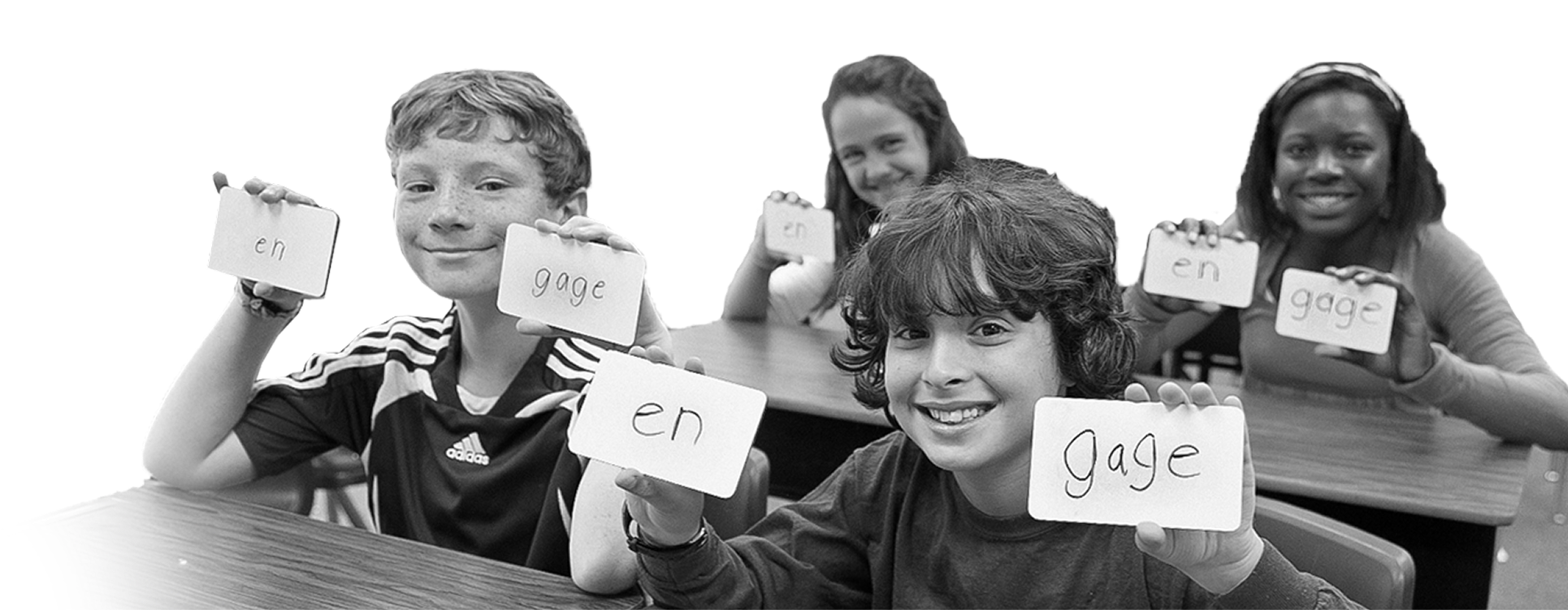 Children in class, holding up flash cards.