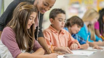 teacher helping kids