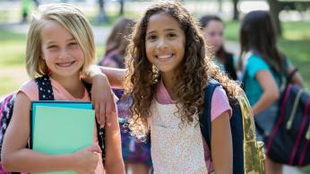 Two girls smiling together.