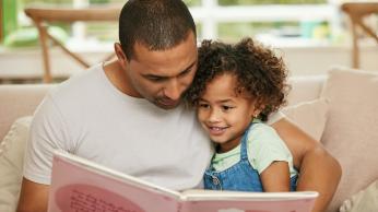 Parent and child reading together.