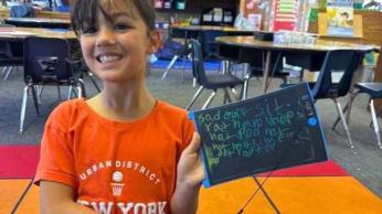 Young girl holding a tablet.