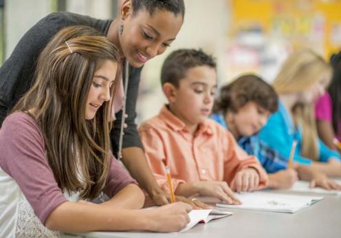 teacher helping kids