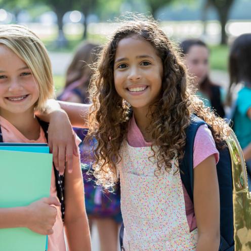Two girls smiling together.