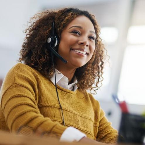 Women with headset on and smiling.