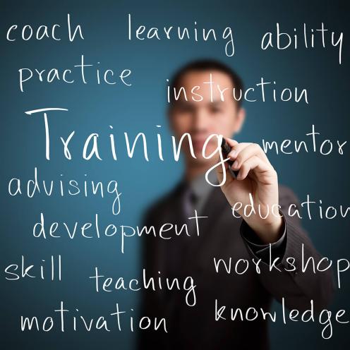 Teacher writing training synonyms on glass.