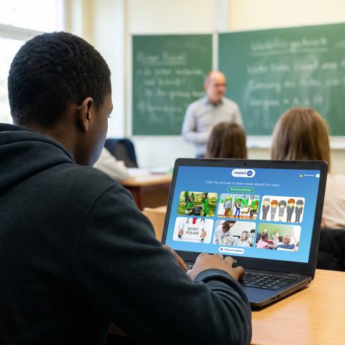 student using laptop in classroom