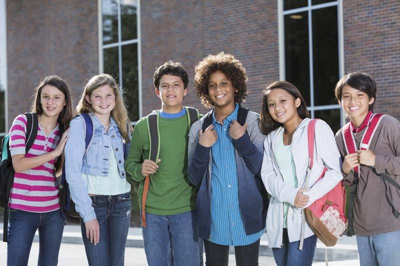 kids outside school with bookbags