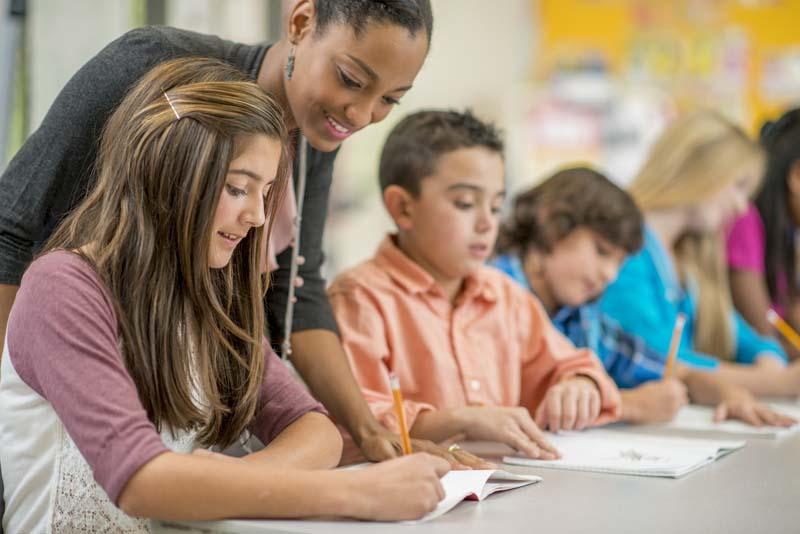 teacher helping kids