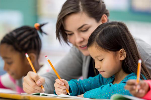 Teacher helping student in class.