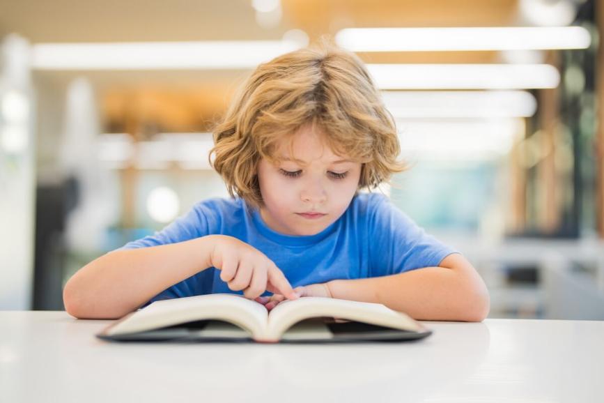 Male student reading a book.