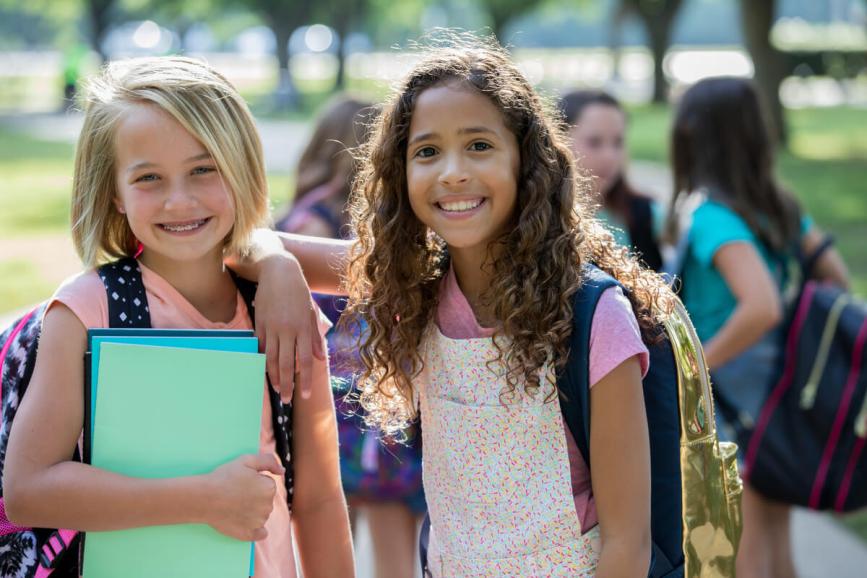 Two girls smiling together.