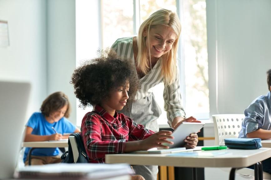 Teacher assisting student during class.