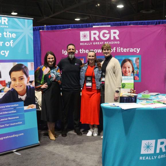 Four RGR members at a tradeshow, posing for group photo.