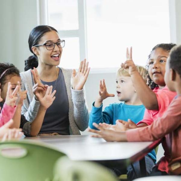 teacher with kids holding up fingers