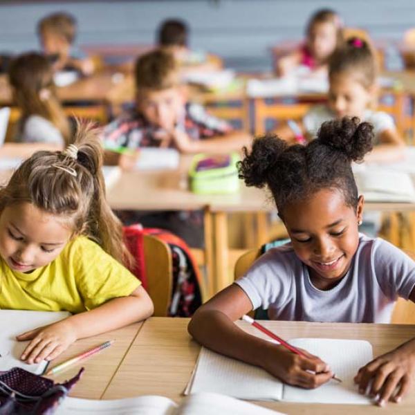 kids at desk writing