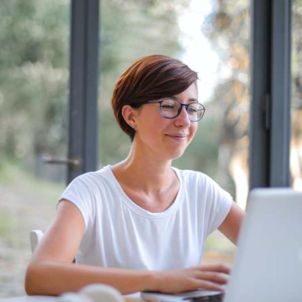 woman-in-white-crew-neck-t-shirt-at-laptop