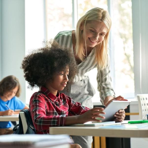 Teacher assisting student during class.